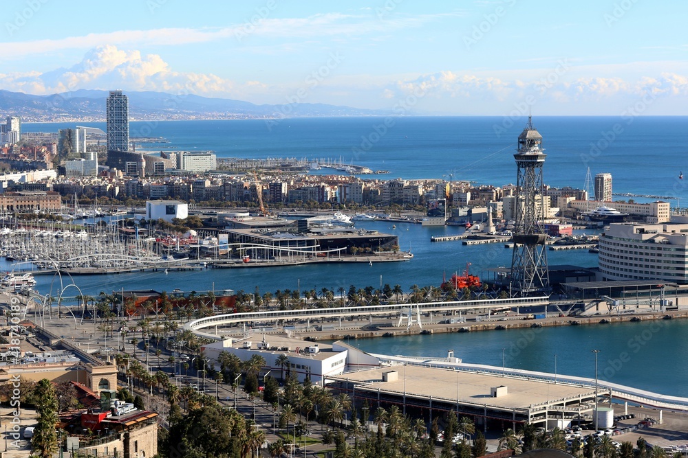 Fototapeta premium View of Maremagnum Shopping Center building and Aerial Tramway Torre Jaume of Port Vell