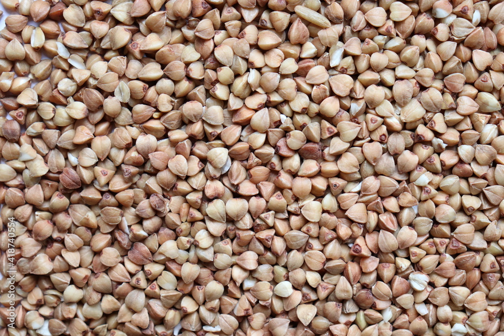 The texture of buckwheat. Background with buckwheat grains. Cereal. Healthy food. The texture of buckwheat. Background with buckwheat grains. Cereal. Healthy food.