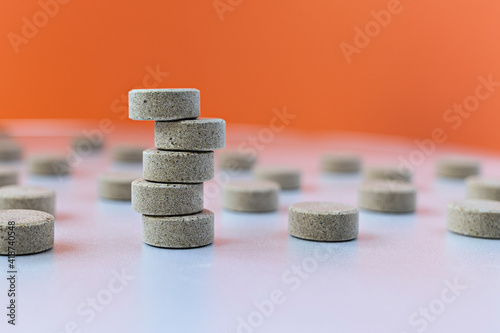 selective focus photo of DGL (licorice root extract) chewable tablets. dietary concept: tower of DGL tablets. dietary supplement topview