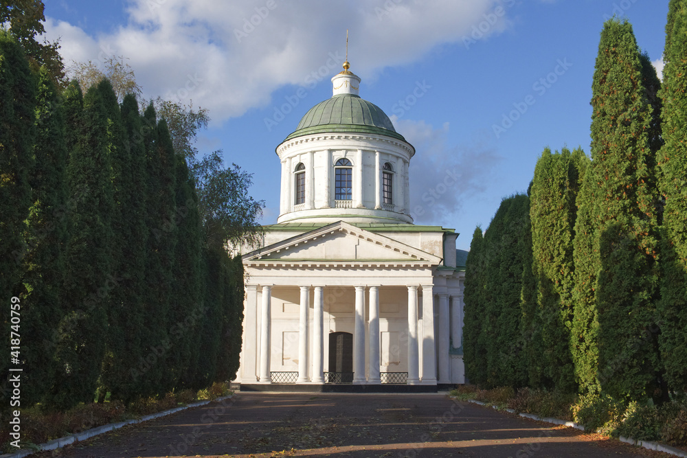 All Saints church in Nizhyn, Chernihivska oblast, Ukraine. Beautiful old building XVIII century with dome for religious purposes, Orthodox Church. Ukrainian baroque architecture. Shady alley. Scenery.