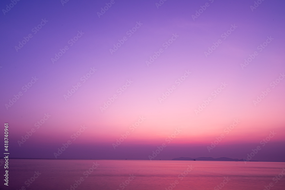 Twilight sunrise sky over tropical sea and beach in Thailand. Purple filtered