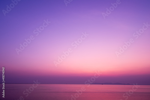 Twilight sunrise sky over tropical sea and beach in Thailand. Purple filtered