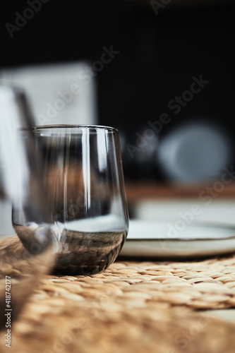 glass goblet on a wicker napkin on the table