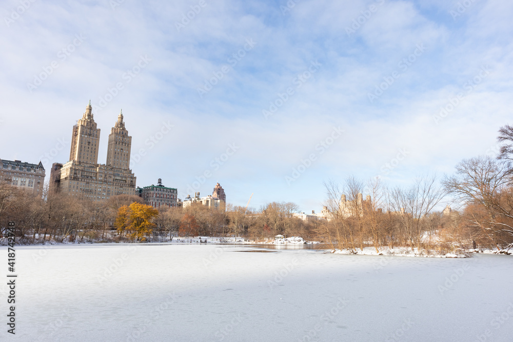 Beautiful Frozen Lake with Snow at Central Park in New York City during Winter with the Upper West Side Skyline