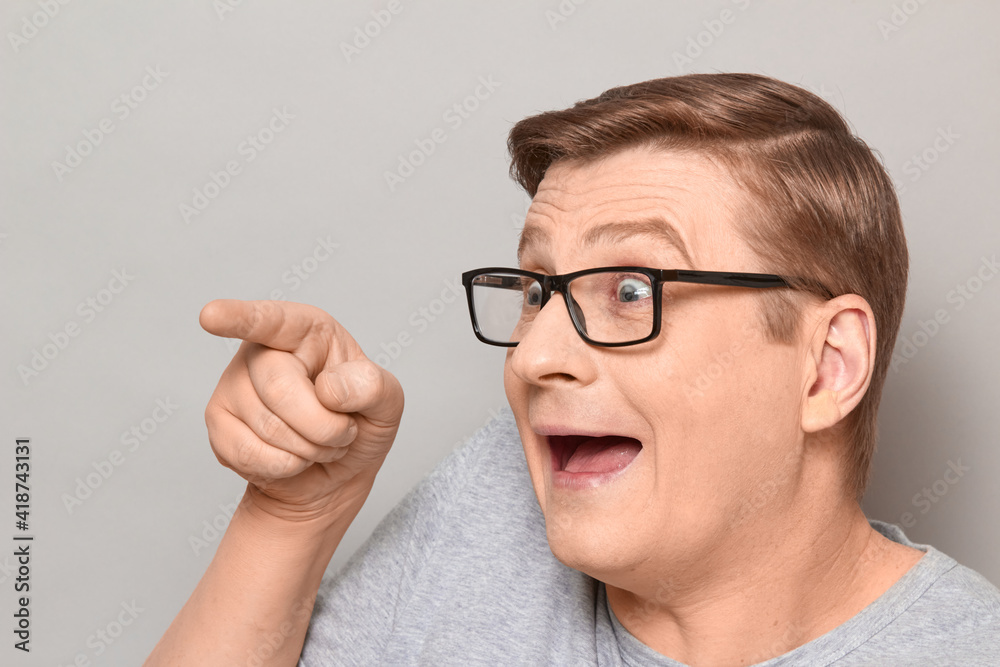 Portrait of happy overjoyed man pointing with finger to the side Portrait of happy overjoyed man pointing with finger to the side