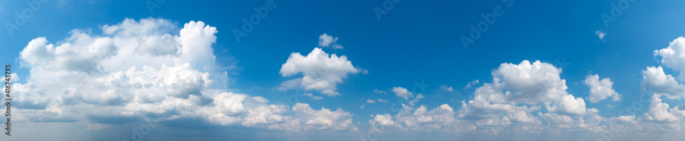 Panoramic fluffy cloud in the blue sky. Sky with cloud on a sunny day. Panoramic fluffy cloud in the blue sky. Sky with cloud on a sunny day.