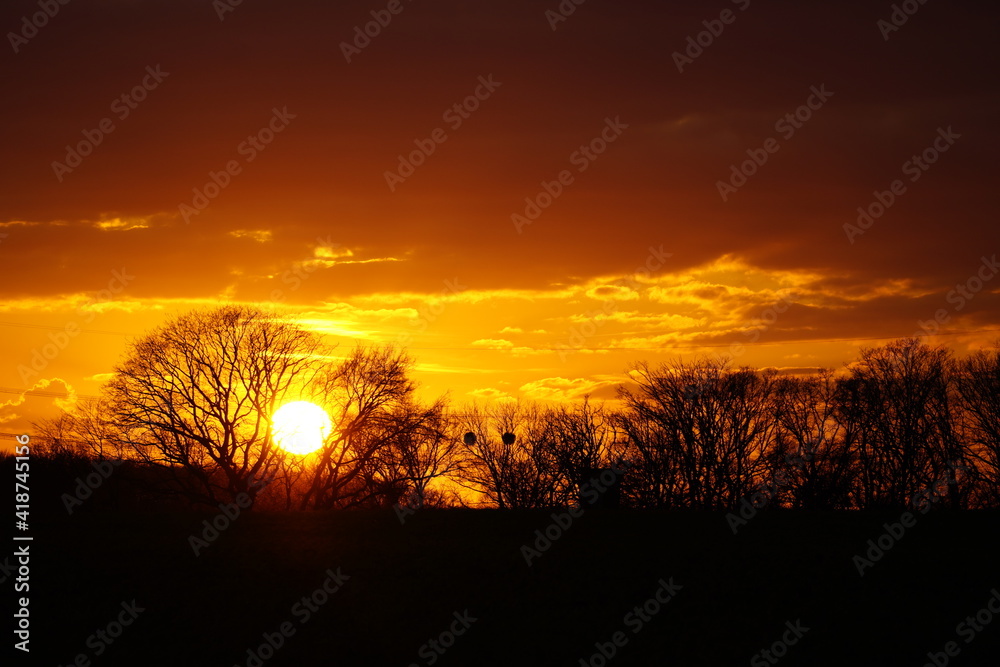 Landscape in the evening in North Rhine Westphalia. Sunset in winter with a dark silhouette.
