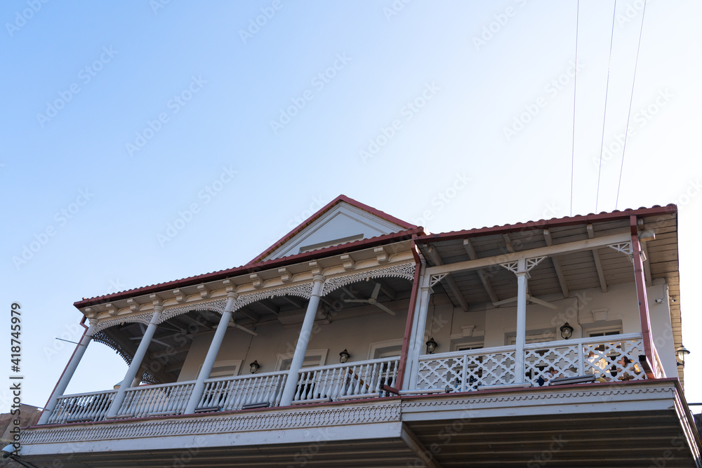 Wooden patterned balcony view from the street Wooden patterned balcony view from the street