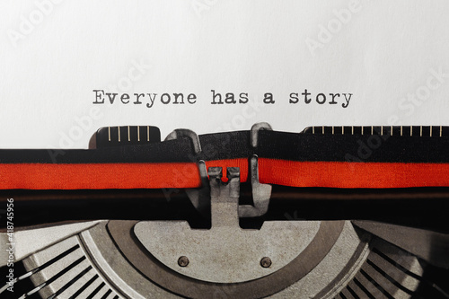 Text Everyone has a story typed on retro typewriter