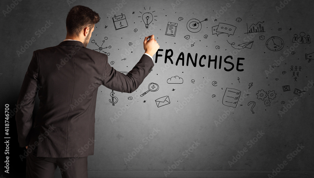 businessman drawing a creative idea sketch with FRANCHISE inscription, business strategy concept