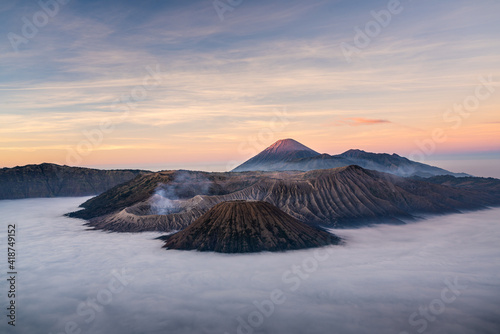 Beautiful sunrise at Bromo volcano mountain in East Java, Indonesia surrounded by morning fog.