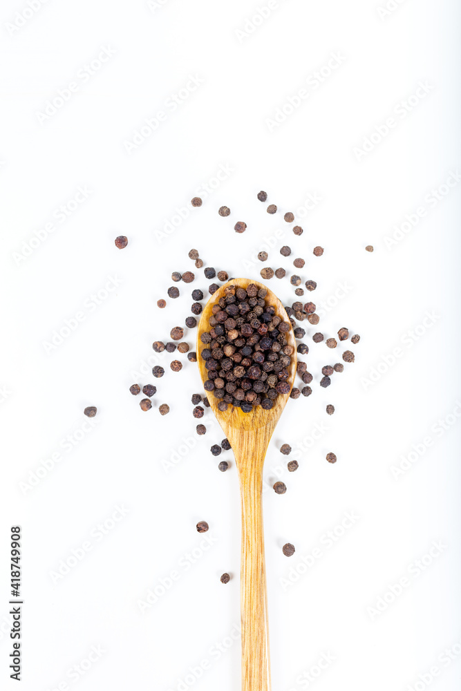 Black peppercorns (Black pepper) seeds in wooden spoon isolated on white background. Black peppercorns (Black pepper) seeds in wooden spoon isolated on white background.