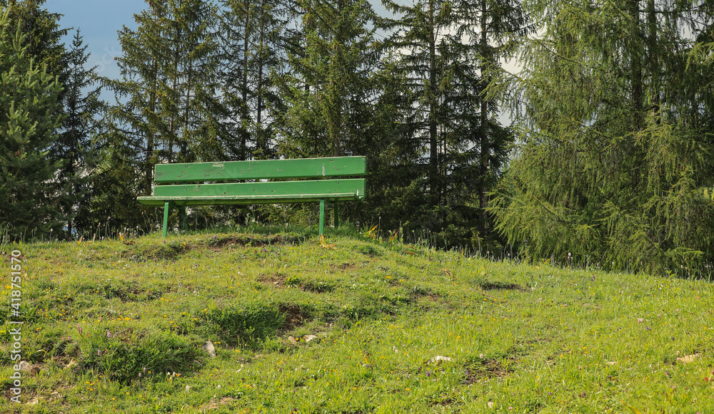 Wooden bench along a mountain pathway, Dolomites, Alta Badia, Italy Wooden bench along a mountain pathway, Dolomites, Alta Badia, Italy