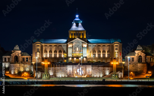 night view of an illuminated old building by the river