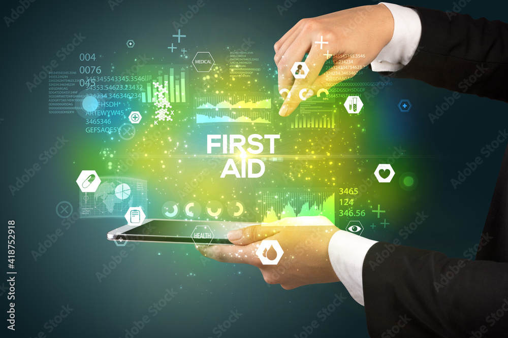 Close-up of a touchscreen with FIRST AID inscription, medical concept Close-up of a touchscreen with FIRST AID inscription, medical concept