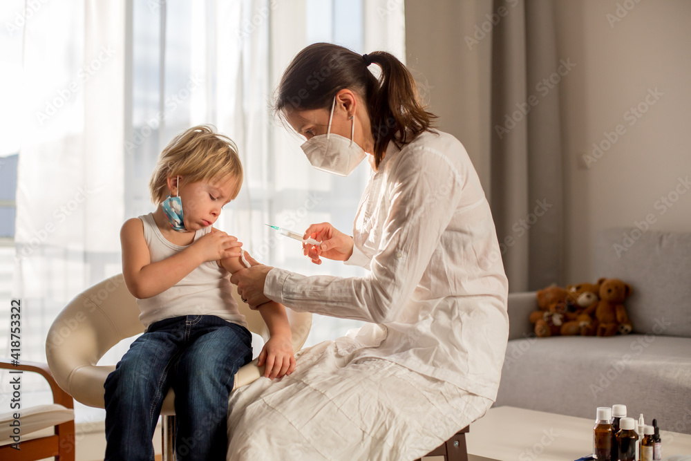 Little toddler boy, getting injection in consulting room from pediatrition Little toddler boy, getting injection in consulting room from pediatrition