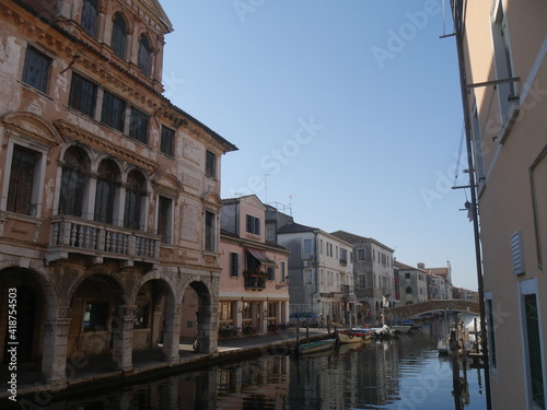 Chioggia, Vena Canal with colorful ancient buildings on both sides and Grassi Palace © filippoph