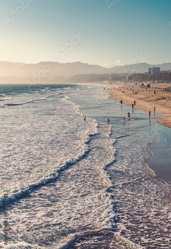 Sunset view with silky sky and golden beach of California, Santa Monica. A summer day