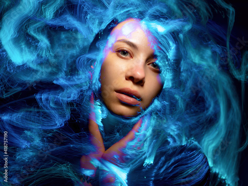 Abstract portrait of a girl in multicolored smoke  light painting photo