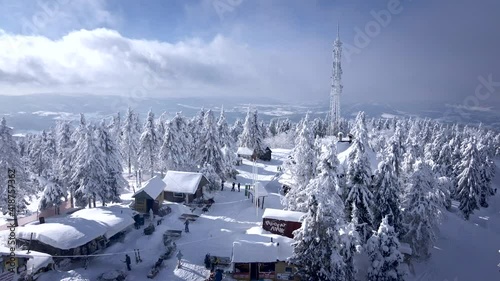 aerial view of the mountain peak people skiing and snowboarding photo