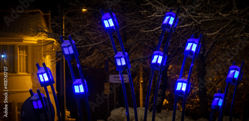 Decorations with blue light on a street at winter night photo