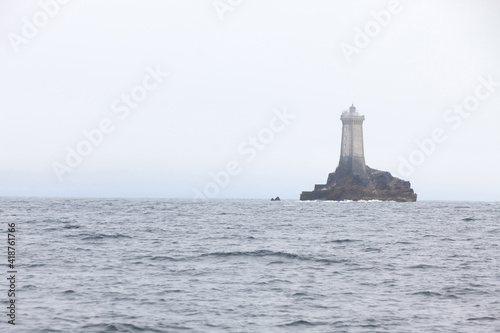 Grey rock lighthouse on Biscay Bay on a cloudy day
