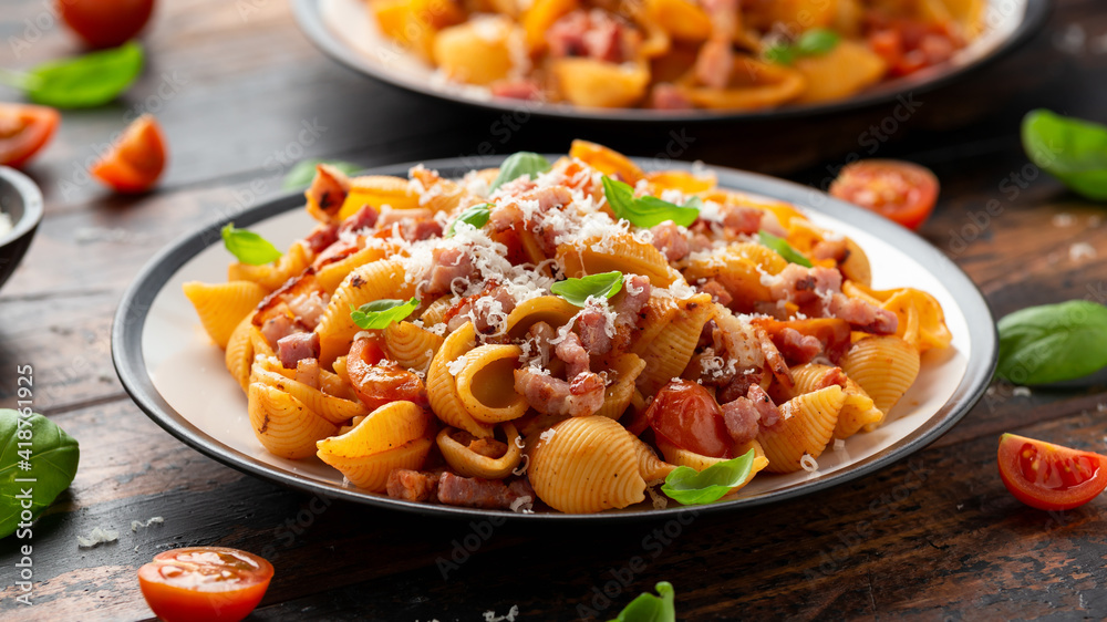 Conchiglie alla Amatriciana pasta with pancetta bacon, tomatoes and pecorino cheese. Healthy Italian food