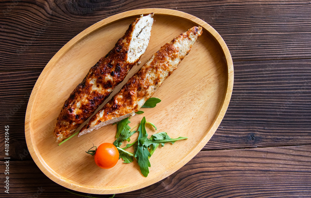 lula kebab fried meat with tomato and herbs on a wooden background lula kebab fried meat with tomato and herbs on a wooden background