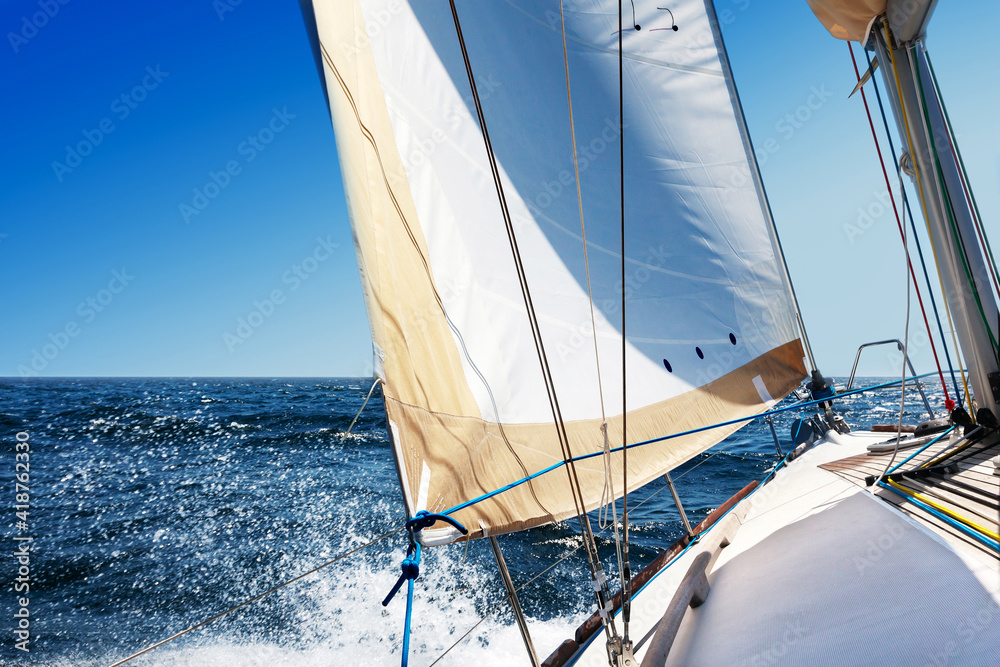 Fototapeta premium Sailing boat at open sea on a bright sunny day