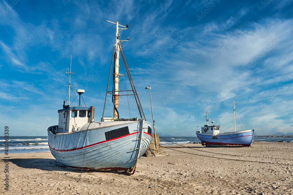 Coastal fishing boats vessels at Vorupoer beach in Western Denmark