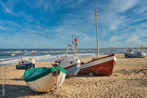 Coastal fishing boats vessels at Vorupoer beach in Western Denmark photo