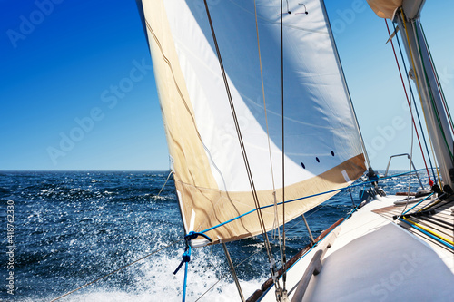 Sailing boat at open sea on a bright sunny day © thakala
