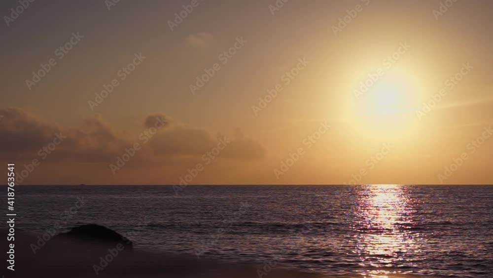 Still shot of a golden sunset over the sea horizon.
The sun sinks behind the horizon and a speedboat treads on the waves. Still shot of a golden sunset over the sea horizon.
The sun sinks behind the horizon and a speedboat treads on the waves.