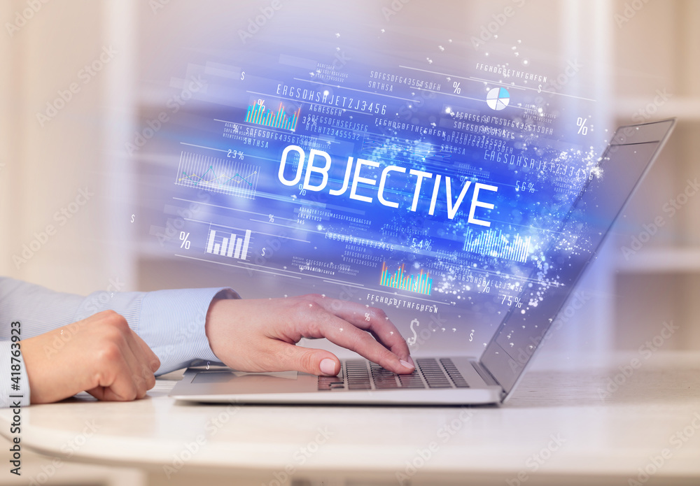 Closeup of businessman hands working on laptop with OBJECTIVE inscription, succesfull business concept Closeup of businessman hands working on laptop with OBJECTIVE inscription, succesfull business concept