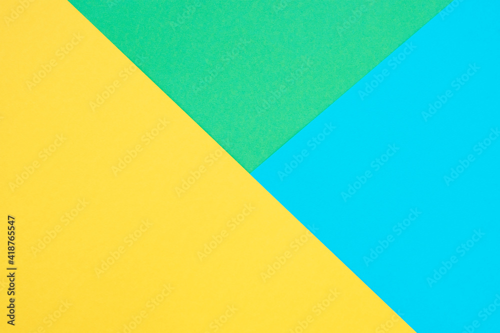 Green, yellow and blue colored paper. Geometric empty paper background, copy space Green, yellow and blue colored paper. Geometric empty paper background, copy space