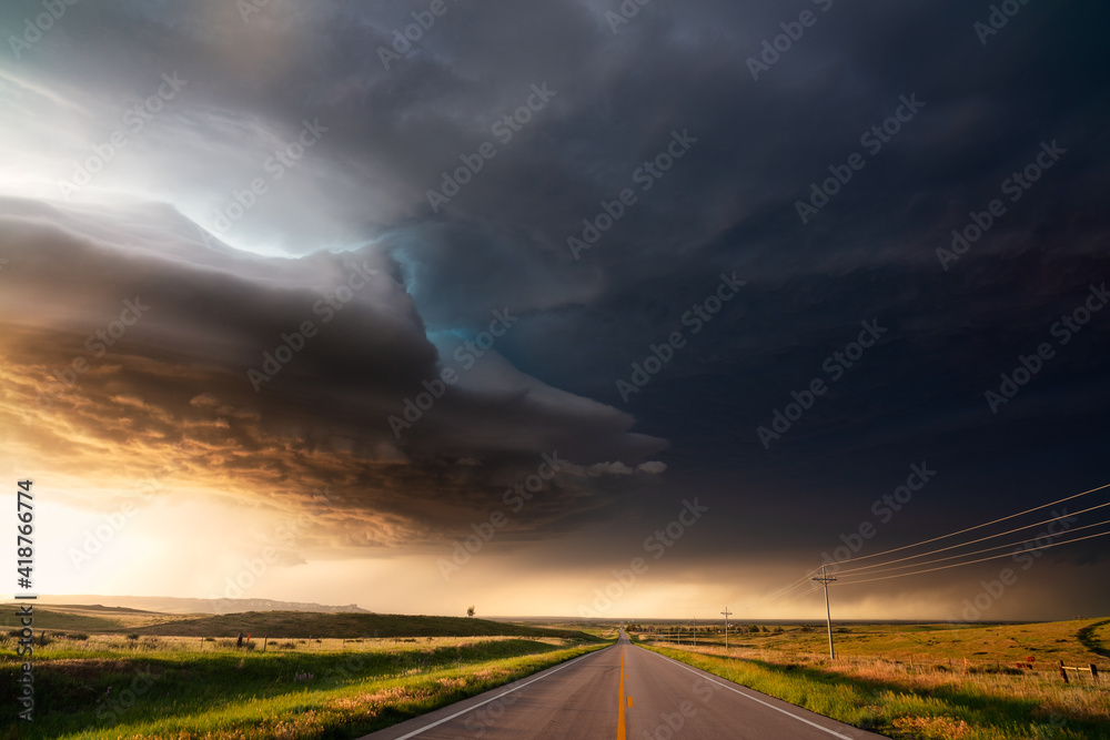 Supercell storm with dramatic clouds over a road at sunset wall mural ...