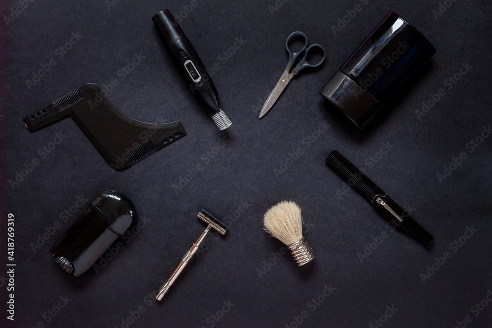 Top view of various men shaving accessories and body care on black background Top view of various men shaving accessories and body care on black background
