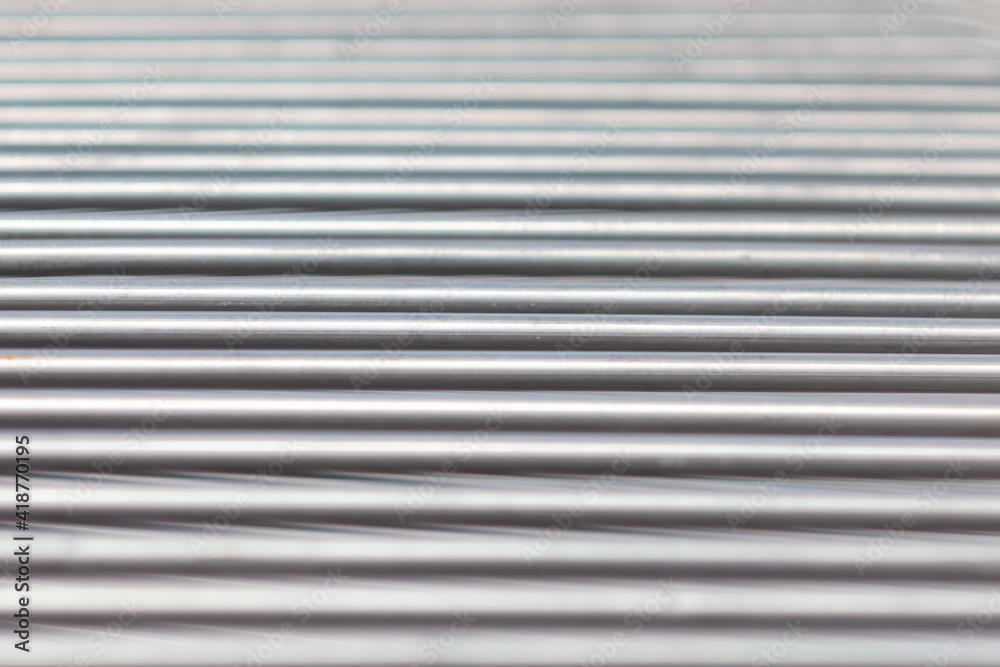 The texture of horizontal parallel lines. Metal sticks close up The texture of horizontal parallel lines. Metal sticks close up