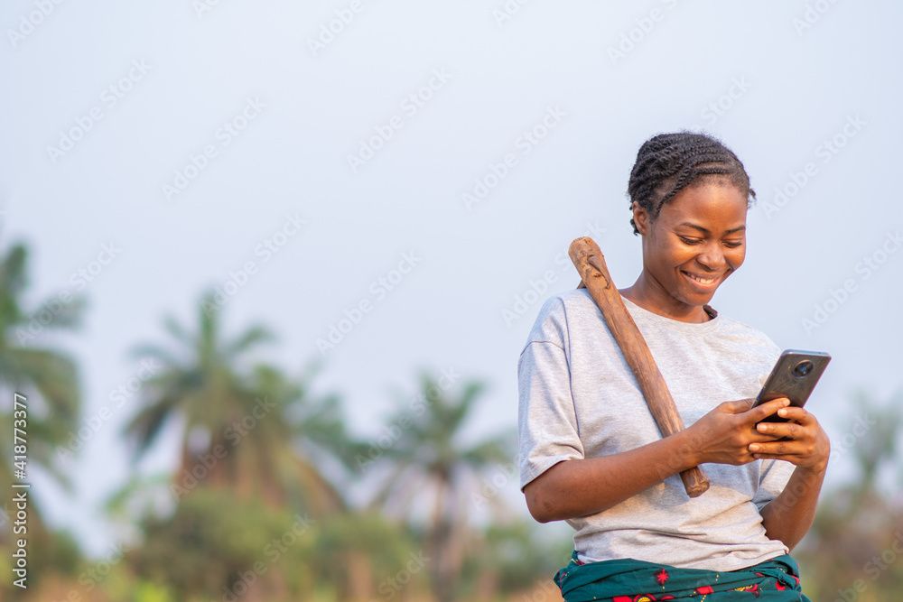 female african farmer using her phone