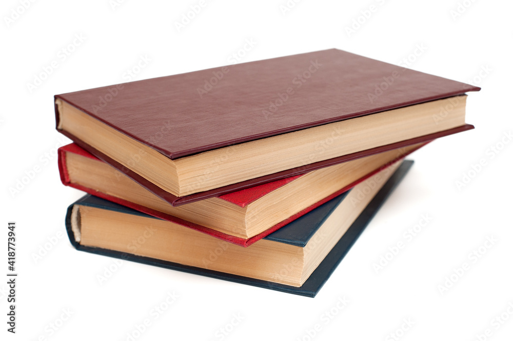Three hardback books lie on a white background Three hardback books lie on a white background