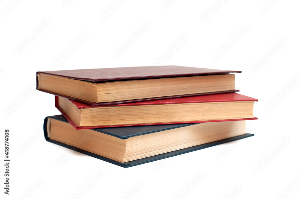 Three hardback books lie on a white background Three hardback books lie on a white background
