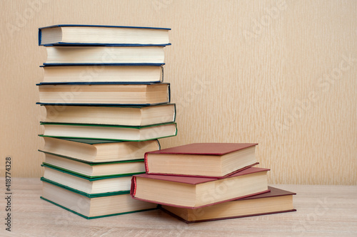 Stack of books on the table on a neutral background