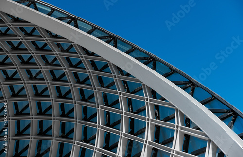 Structural glass facade curving roof. Abstract architecture fragment