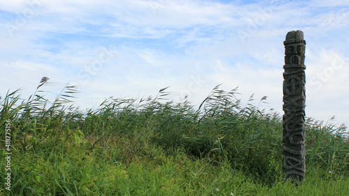 A statue of the Slavic deity, Ziemowit in green grass.