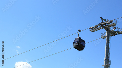 Ski-lift carriages on a background of blue sky in summer