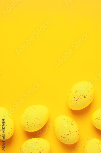 Easter yellow eggs on a yellow background. Flat lay, copy space.