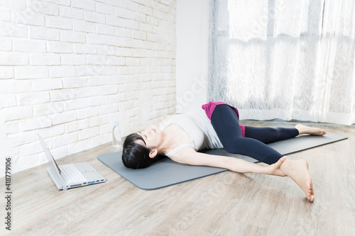 Woman doing yoga while checking the pose