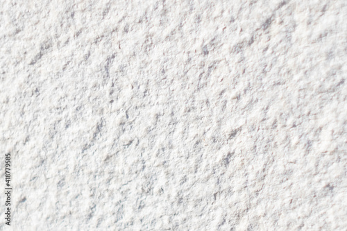 Texture of rough surface of a white stone wall close-up