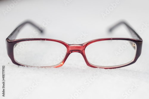 dark plastic-rimmed glasses in the snow