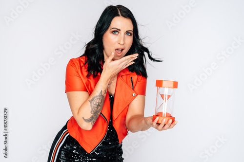 Beautiful young woman with hourglass isolated over white Sanduhr rot red black dress red jacket black hair